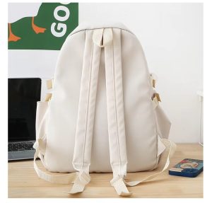 Back view of beige student backpack with adjustable straps and side pocket