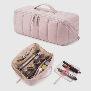 Home A light pink quilted travel bag shown closed and open displaying hair tools secured by elastic bands and a separate flat mat.