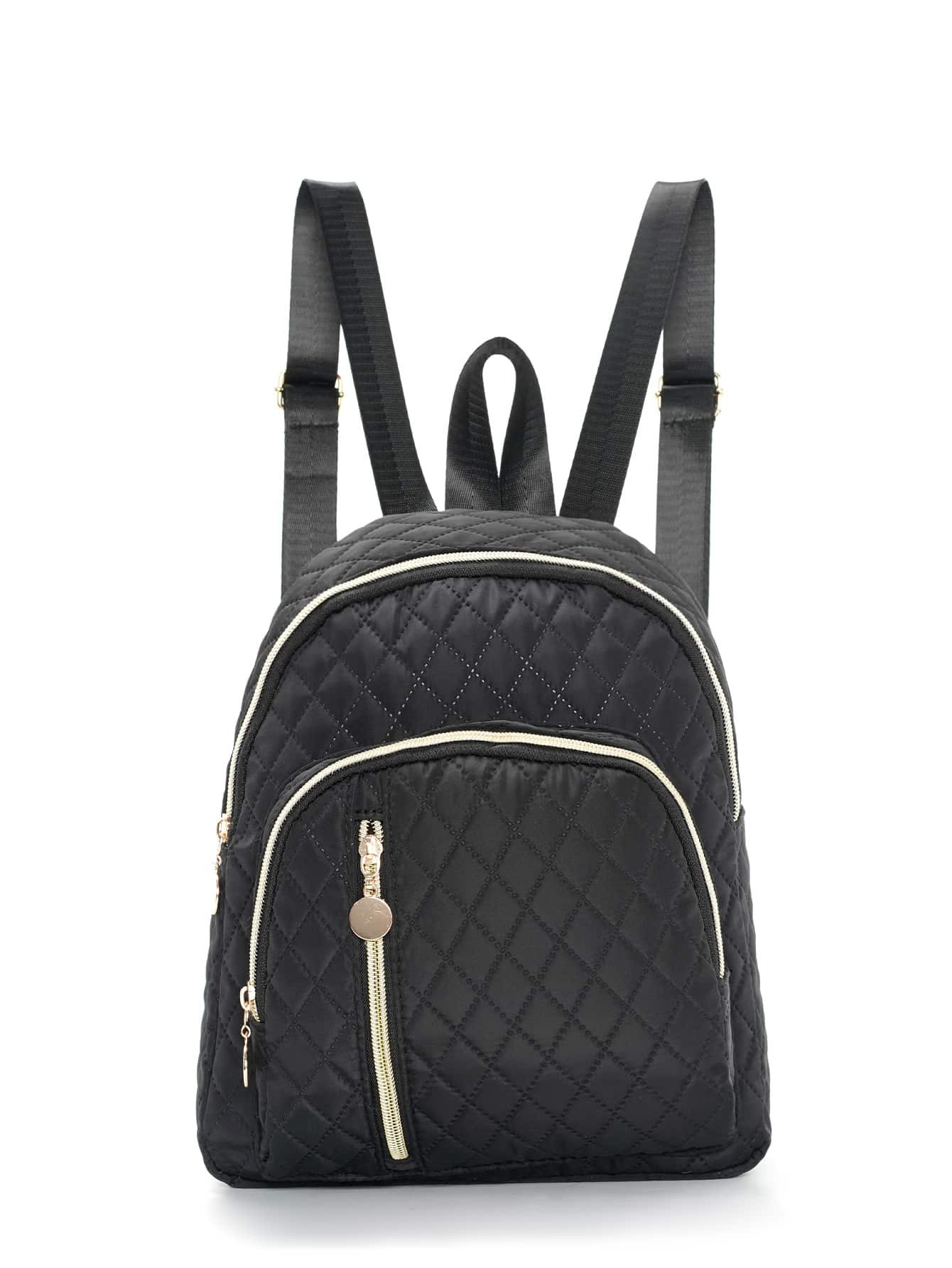 03 A front view of the black quilted mini backpack next to a blue smartphone showing its compact size.