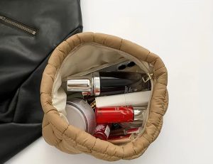 puffer quilted handbag holding cosmetics and daily essentials